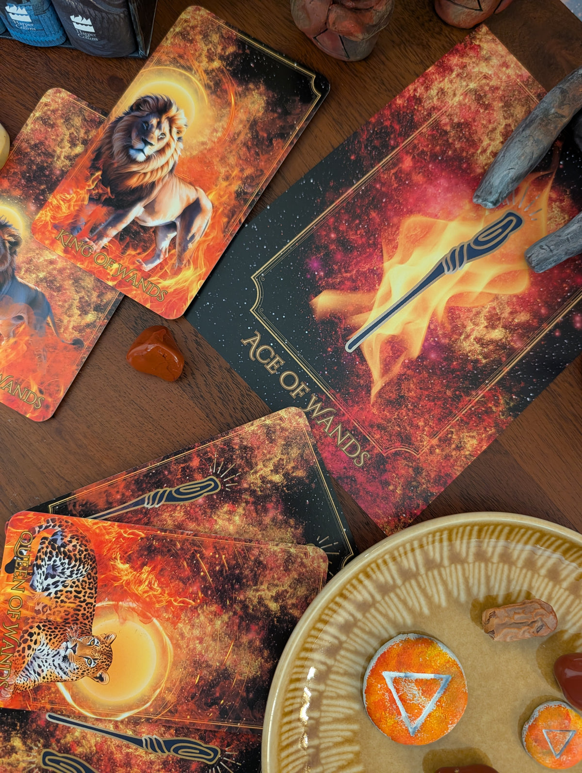 Written in the Stars Tarot cards by Emporos — Ace, King and Queen of Wands Fire element spread on a wooden altar with crystals, used for Sekhem healing and spiritual practice