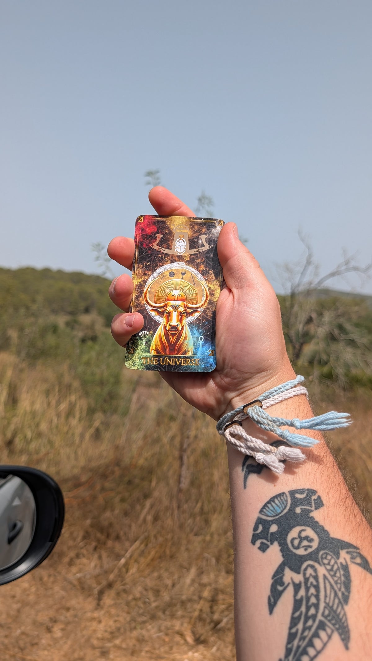 Written in the Stars Tarot Deck by Emporos — The Universe Higher Arcana card held outdoors, plastic-free tarot designed in Devon and printed in Cornwall
